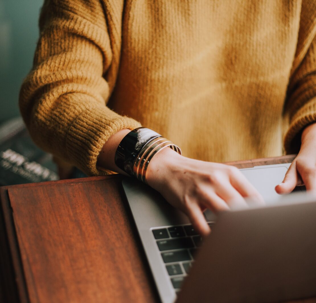 person at desk working on a laptop